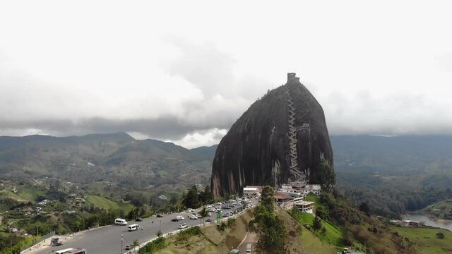 Aerial lowering shot of famous tourist destination Piedra del Penol. wide angle