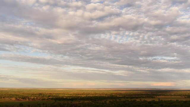 Time lapse of plain landscape in Serengeti at sunset. Static