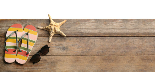 Shoes, sunglasses and starfish on wooden table, space for text. Beach accessories