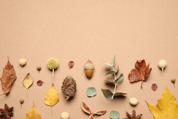 Fototapeta na wymiar Flat lay composition with autumn leaves on beige background, space for text