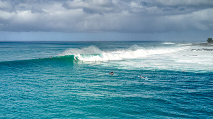 Aerial View of a Surfer Catching a Large Wave at Waimea Bay, Hawaii - obrazy, fototapety, plakaty