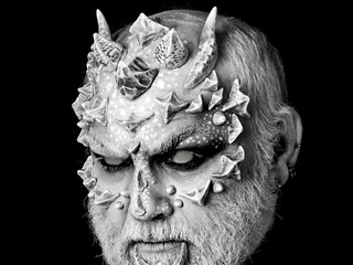 Devil with dragon skin and grey beard. Evil monster with sharp thorns and warts on face. Horror and...
