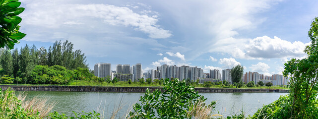 Panoramic view of Singapore Public Housing Apartments in Punggol District, Singapore. Housing Development Board(HDB), View from the park with green grass field and lake