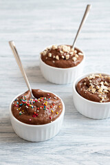 Banana ice cream with cocoa and nuts. Delicious and healthy dessert. Close-up, vertical orientation.