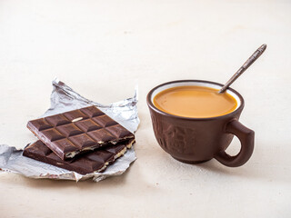 Coffee with cream and halves of chocolate bar with mint filling