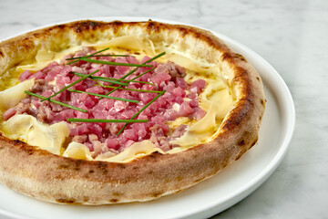 Juicy pizza with white sauce, tuna, cream cheese and ginger. Italian pizza with seafood from wood oven on wood board on marble background