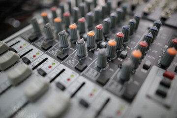 Shallow depth of field (selective focus) image with the controls on an audio mixer