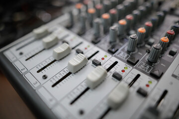 Shallow depth of field (selective focus) image with the controls on an audio mixer