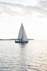 Obraz na płótnie Canvas Sailboat in the sea in the sunset, luxury summer adventure, in Mediterranean sea, Europe