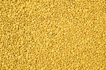 Golden bee pollen granules abstract background