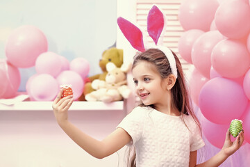 Happy easter. Child with Easter eggs. Cute little girl wearing bunny ears.