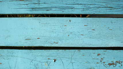 old dirty wooden planks with cracked blue paint