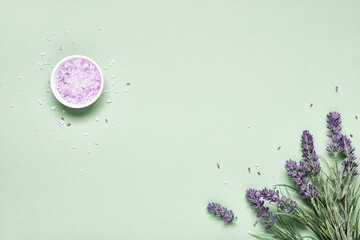 Lavender flavored sea salt and bouquet of lavender on mint green background. Aromatherapy treatment...
