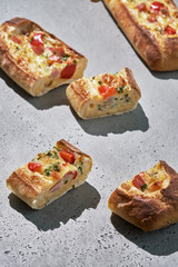 Bread boats stuffed with ham, egg, green onion and cheese for breakfast