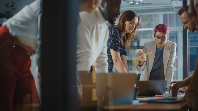 Diverse Team of Professional Businesspeople Meeting in the Office Conference Room. Creative Team Around Table, Specialist with Short Pink Hair Speak for Marketing Compain, Social Media Strategy