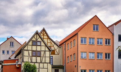 Old half timbered house next to a new house in the old town of Wismar.
