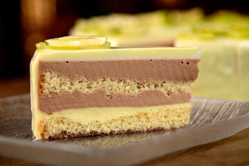 Piece of lime cheesecake on the old wooden board, close up