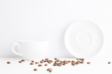 Empty cup of coffee on white background with coffee beans.