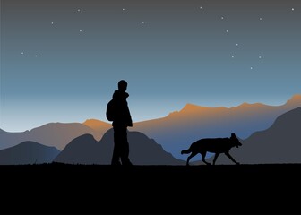 Silhouette of a man and a dog walking on a cliffin the mountains at sunset.