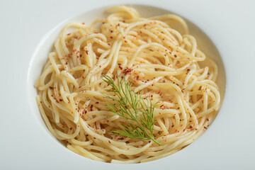 Delicious spaghetti with greens in a white plate