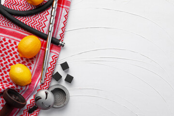 Hookah parts and lemons on red napkin on white background