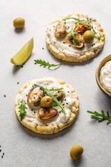 Bruschetta with mussels, cheese, crisp breads Mussels bruschetta, toast with soft cheese and arugula, banner, top view, vertical image, place for text