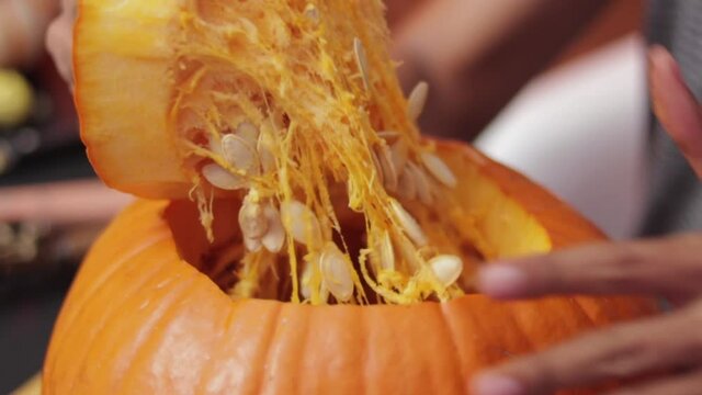 Someone carving pumpkin for halloween season.