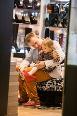 Little girl with father in the shoes  shop