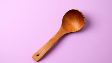 wooden spoon on pink background