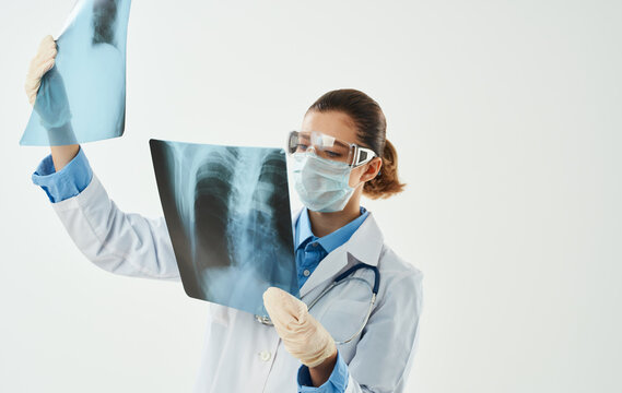 Doctor in a medical gown with an X-ray picture gesturing with his hands Copy Space emotion