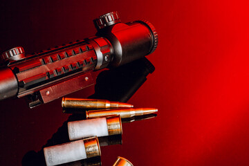 Optical scope for rifle on black background with red light