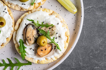 vegan sandwich with mussels, Crisp bread, soft cheese and arugula salad. Set of tasty appetizer bruschetta. Food recipe background. Close up, top view