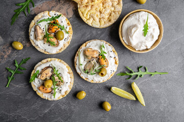 Preparing delicious Mussels bruschetta, Crisp bread toast with soft cheese and arugula, banner, menu recipe place for text, top view