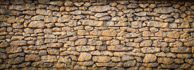 old solid wall of rough stones in Europe