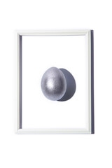 Top view of silver gray yellow colored egg and its shadow in frame isolated over white background. Easter celebration concept. Creative greetings. 