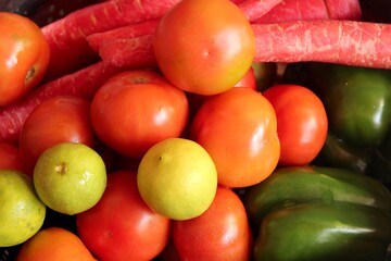 Fresh vegetables background. Tomatoes and lemons.