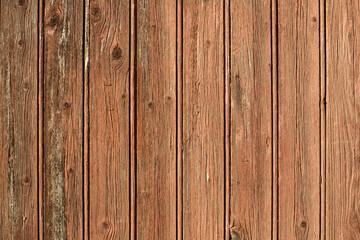 Naklejka premium Texture d'une vieille porte en bois avec des planches marron au soleil