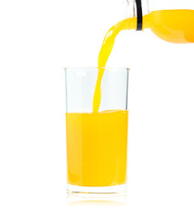 Yellow orange juice poured from a plastic bottle and put into a clear glass, the drink is processed from natural citrus fruit, contains vitamins and calcium, white background isolated.