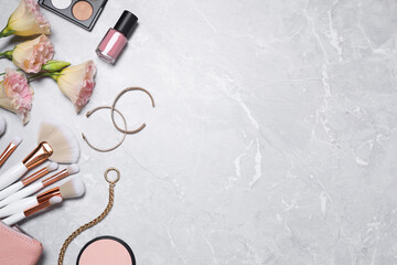 Fototapeta na wymiar Flat lay composition with makeup products and accessories on light grey marble background. Space for text