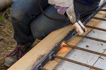 A man welds a metal frame to build an aviary, welding metal close up.