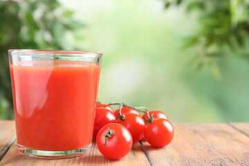 Delicious tomato juice and vegetables on wooden table. Space for text