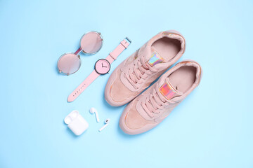 Flat lay composition with stylish shoes and accessories on light blue background