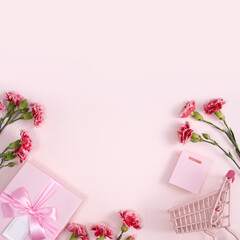 Concept of Mother's day holiday greeting with carnation bouquet on pink background