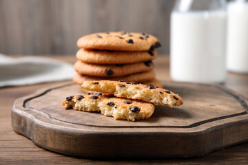 Delicious cookies with chocolate on wooden board