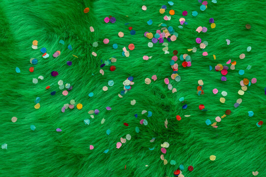 fashing meadow with fashing paper, confetti on it. The meadow is made of green imitation fur. Great background theme
