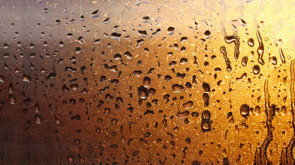 Drops condensation on the clear glass window. Water drops. Abstract background texture, condensation on the glass with dripping drops