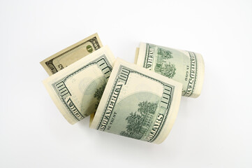 one hundred dollar bills rolled up, on an isolated white background