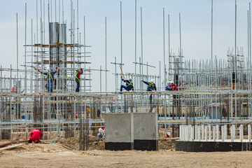 Oil refinery plant modernization. Development of reinforcement concrete. Industrial climbers on assembling scaffolding