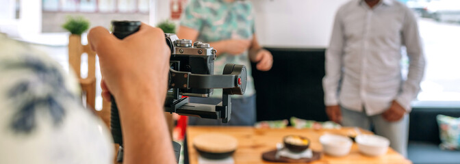 Fototapeta na wymiar Unrecognizable camera operator recording cooking workshop