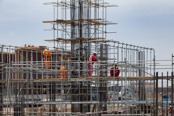 Industrial climbers on assembling scaffolding. Oil refinery plant modernization. Development of...